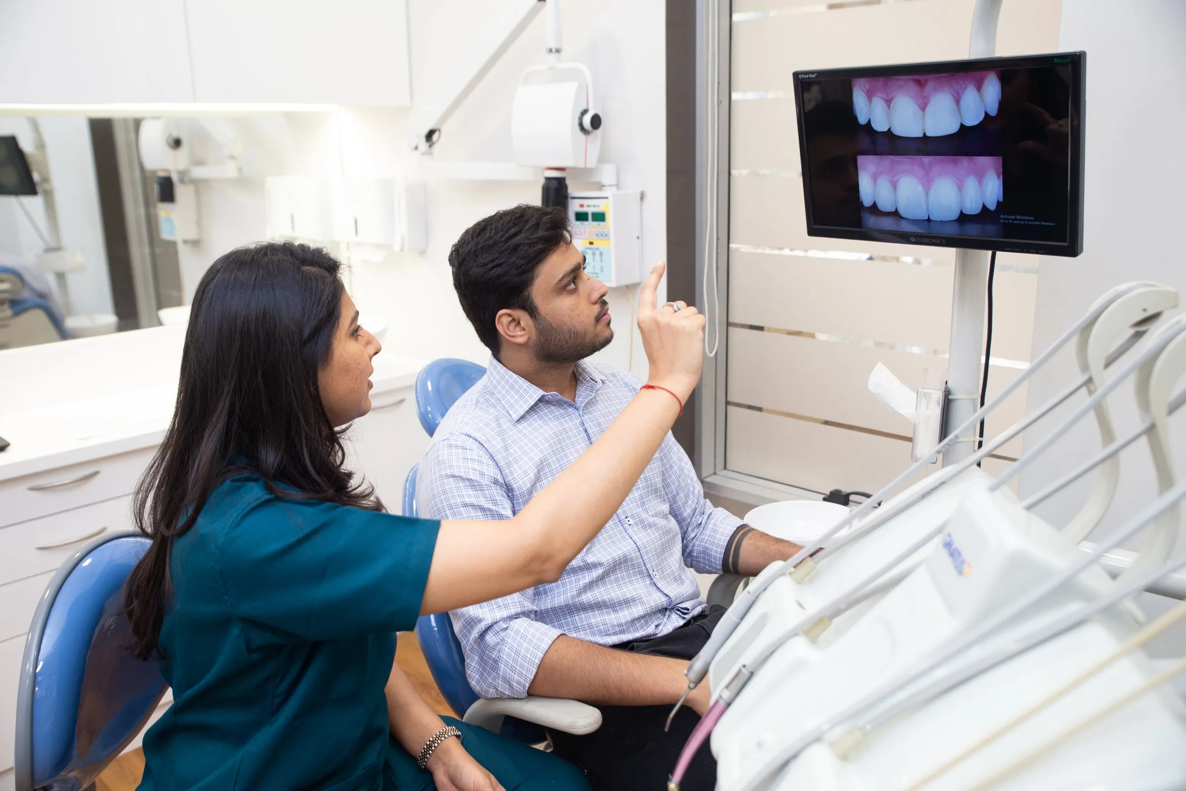 Patient viewing intraoral camera images with Dr. Upasana